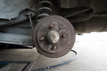 Rusty Rear Car Wheel Hub with Drum Brake System and Suspension