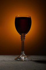 Dry red wine on an orange background