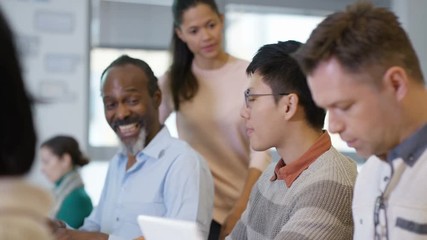  Group of mature students in adult education class, working on laptop computer
