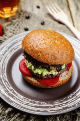 black bean burger with mashed avocado, caramelized onions and to