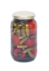 Marinated organic tomatoes and pickles in jar separated on white background