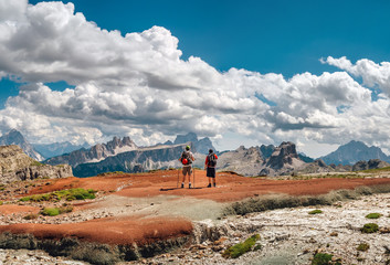 Mountaineers friends a top Mount admiring the view of the Dolomites
