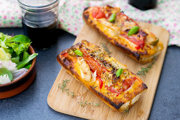 Grilled open faced sandwich with tomato, olives, cheese and chic