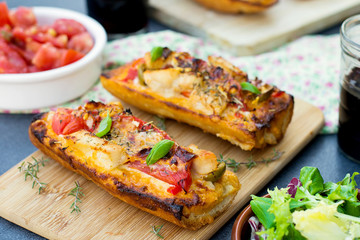 Grilled open faced sandwich with tomato, olives, cheese and chic