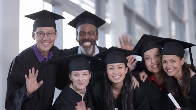 Portrait of happy group of mature students on graduation day