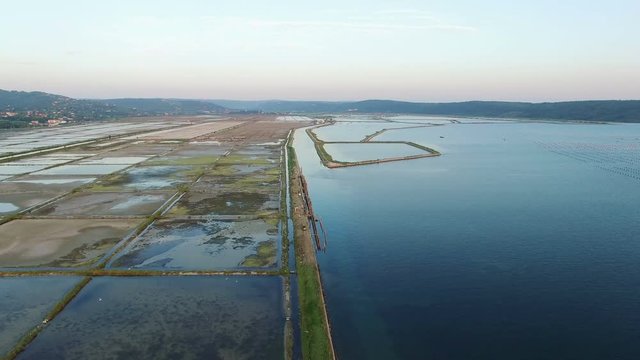 4K. Flight over soline in Slovenia on sunset, place of extraction of sea salt, aerial panoramic view. Secovljske Soline, Slovenia.