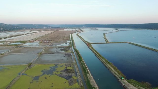 4K. Flight over soline in Slovenia on sunset, place of extraction of sea salt, aerial panoramic view. Secovljske Soline, Slovenia.