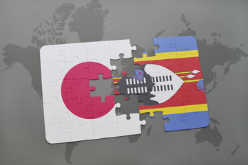 puzzle with the national flag of japan and swaziland on a world map background.