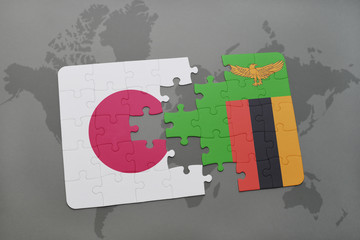 puzzle with the national flag of japan and zambia on a world map background.
