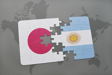 puzzle with the national flag of japan and argentina on a world map background.