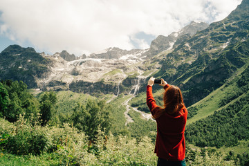 Fototapeta na wymiar Woman photographing mountains