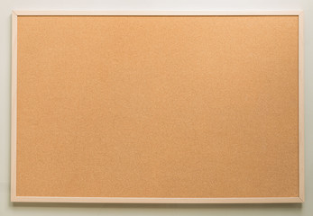 brown cork board on white wall background