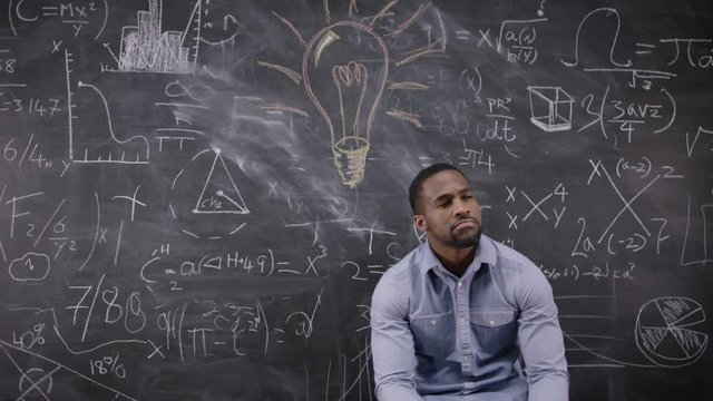  Happy little scientist with fake mustache writing math formulas on blackboard