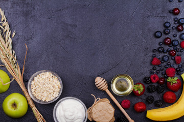 Yogurt, Oat Flakes, Fresh Apples, Honey and Summer Berries. View from above, top studio shot of fruits