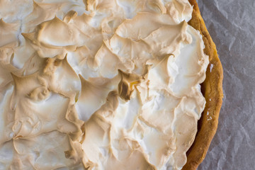Detailed view on Meringue cake with strawberry jam on baking pap