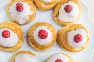 Top View on Raspberries Profiterole with White Chocolate on Plat