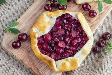 Top View on Rustical Sour Cherry Pie on Jute Fabric with a few s