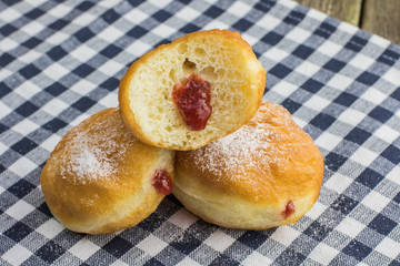 Half berliner (doughnut) with strawberry jam