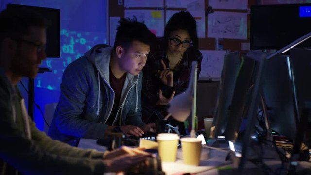  Team of young computer hackers trying to gain access to a computer system