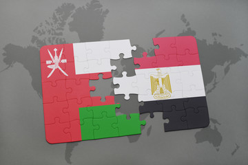 puzzle with the national flag of oman and egypt on a world map background.