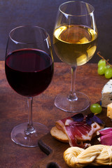 Red and white wine. Smoked cheese, grape, prosciutto, garlic and bread