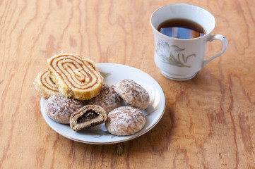 Roll cakes and tea on the saucer near