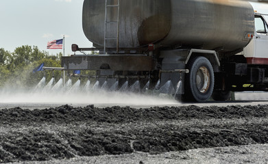 Road Construction Water Truck spraying Water on Jobsite