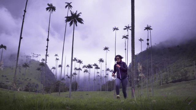 Woman running on the tropical forest of a National park Valle del Cocora, Colombia. Slow motion