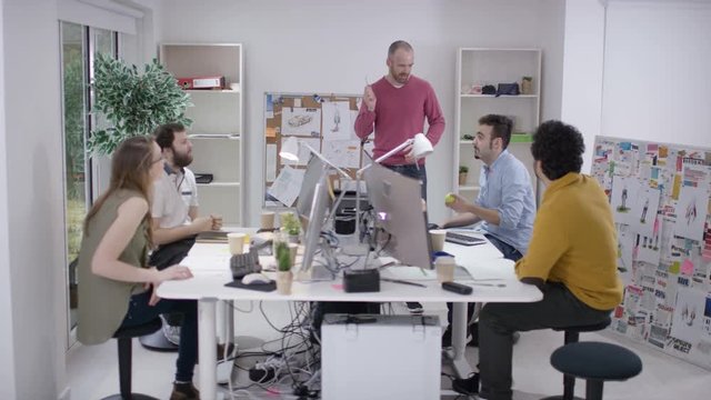  Casual creative business team brainstorming for ideas in office meeting