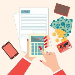 Top view of woman hands holding calculator to calculation tax fo
