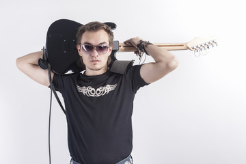 Portrait of Young and Tranquil Caucasian Guitarist Posing Against White