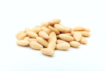 White peeled almonds on white background