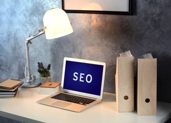 SEO technology concept. Modern workplace interior.