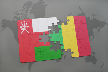 puzzle with the national flag of oman and mali on a world map background.