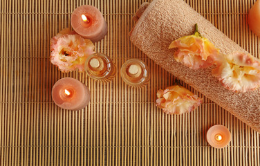 Beautiful spa composition with flowers on mat