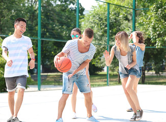 Teenagers playing basketball