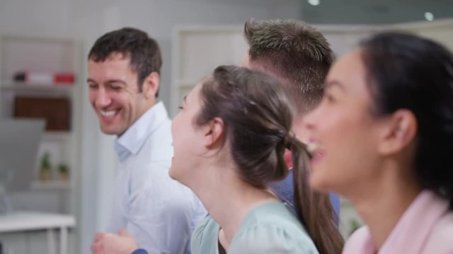  Happy business group laughing & clapping the speaker at business presentation