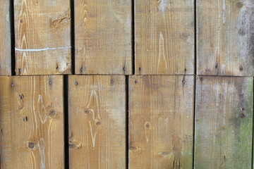 The old boards painted with a brown paint and green mold