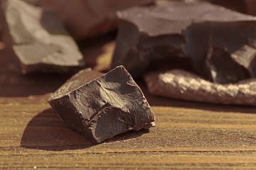 Chocolate chunk on wooden table, closeup