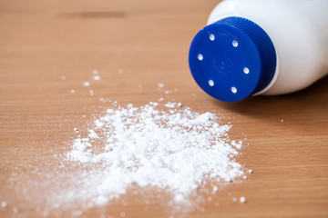 Talcum powder on wooden background
