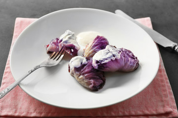 Cabbage rolls with sauce on plate, closeup