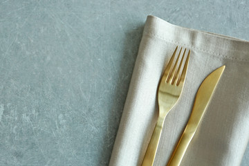 Table setting with fork, knife and napkin, closeup