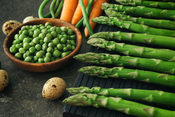 Fresh vegetables and asparagus on kitchen table