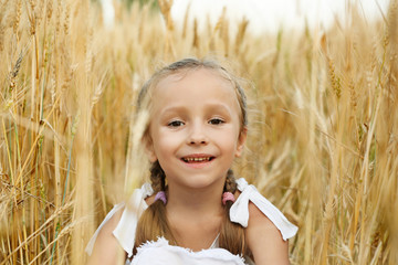 Little happy girl in the field