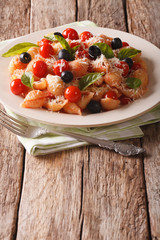Italian cuisine: pasta with tomatoes, olives and parmesan cheese. vertical
