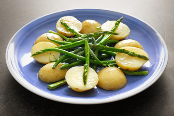 Fresh asparagus with potatoes on plate