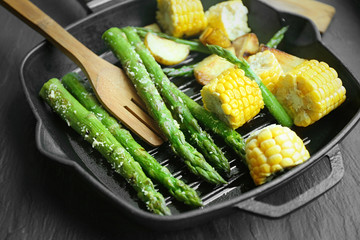Grilled asparagus with vegetables on frying pan