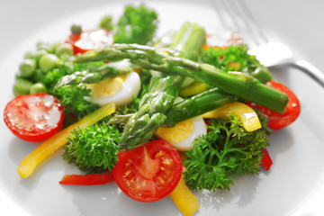 Asparagus with vegetables on plate