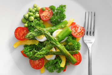 Asparagus with vegetables on plate
