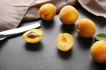Apricots with knife on table